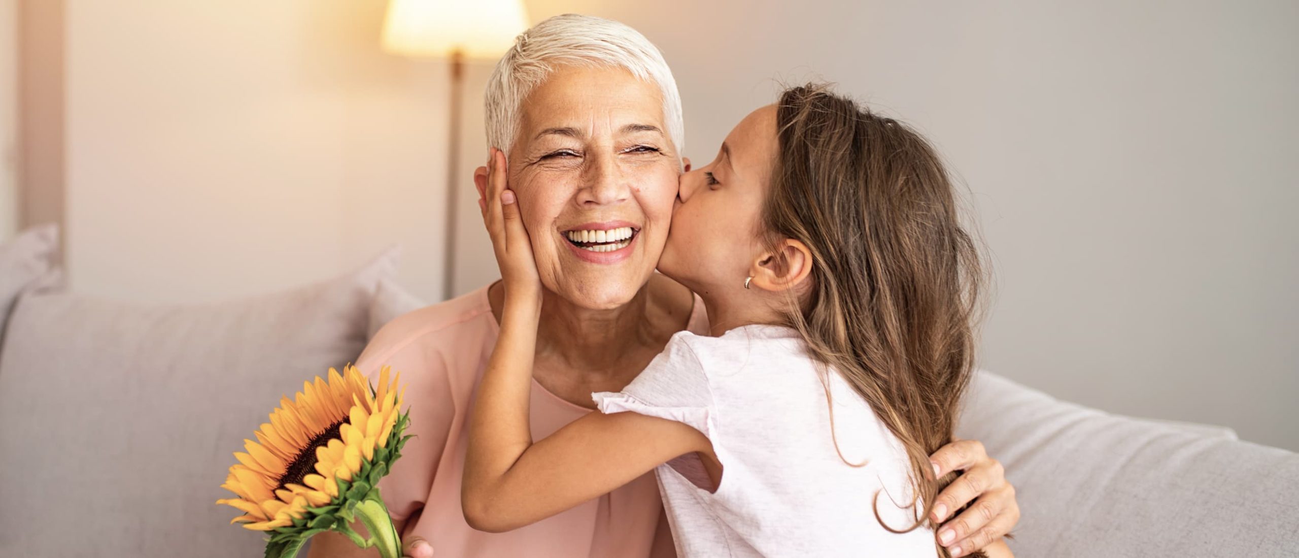 Child kissing older woman on cheek.